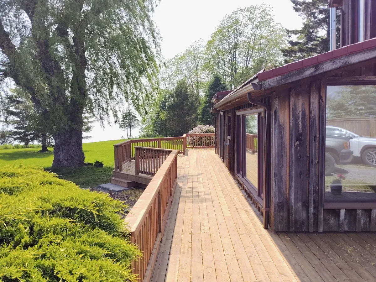 Newly rebuilt cedar deck and walkway with fresh picket railings