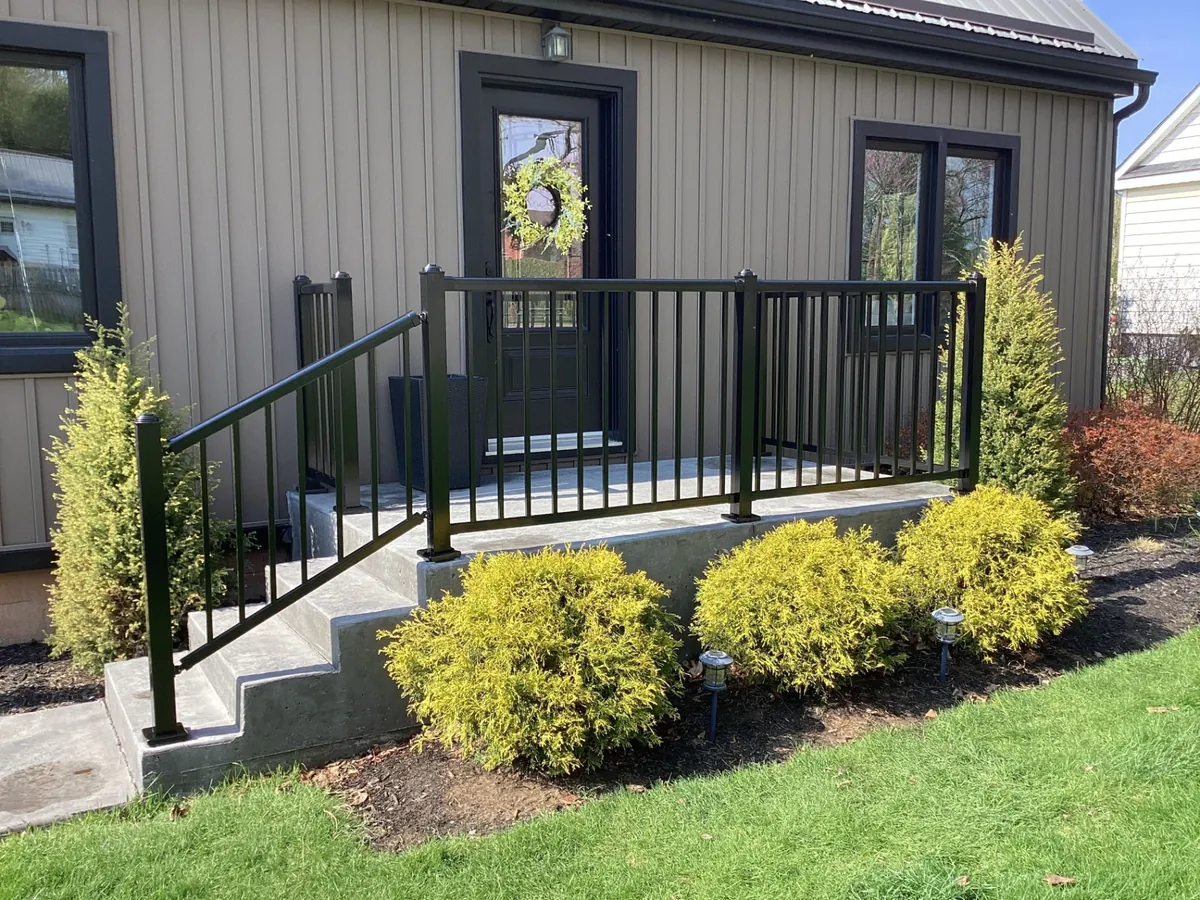 Concrete front porch with aluminum railings