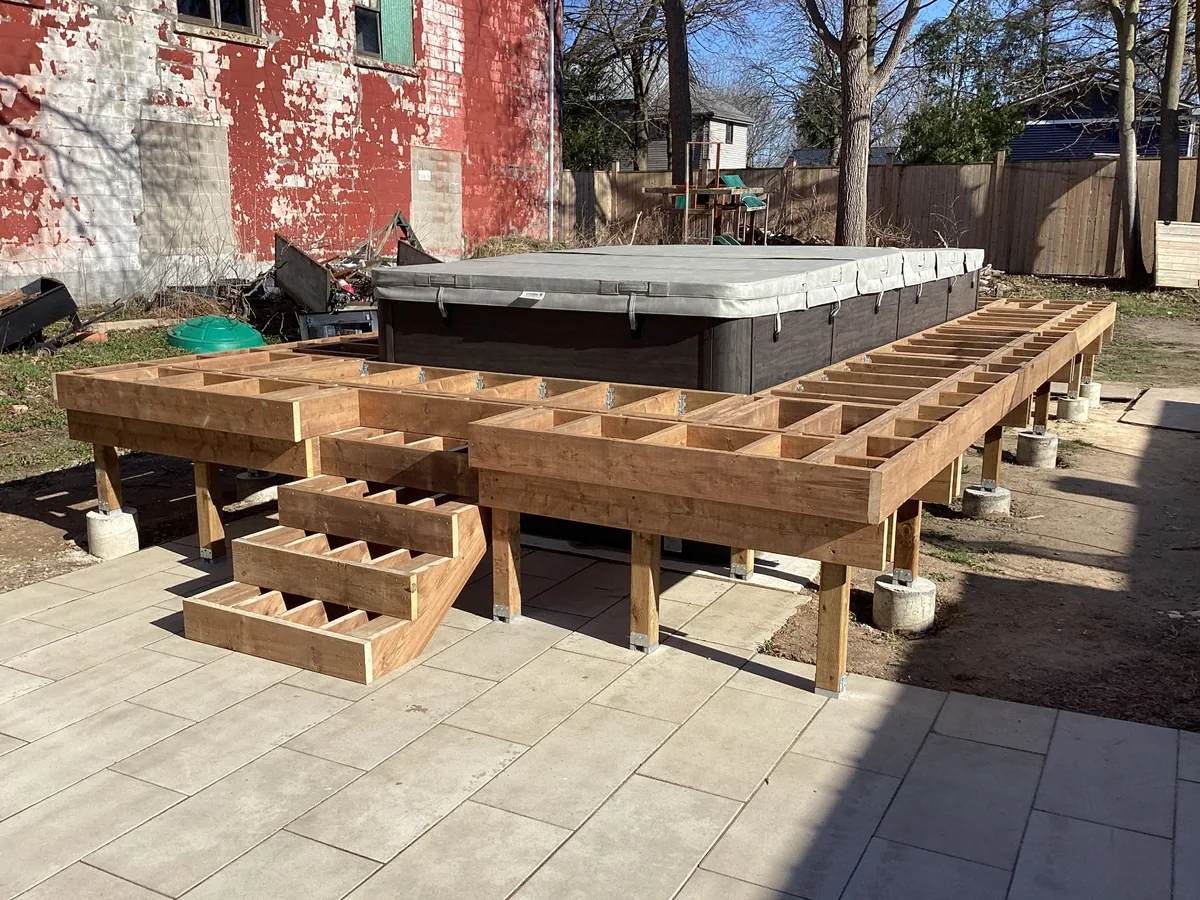 Heavy duty cedar deck framing on concrete piers around hot tub