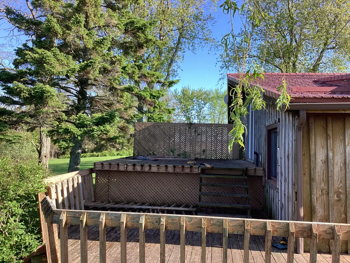 Old deck and railings stripped down to framing during demolition