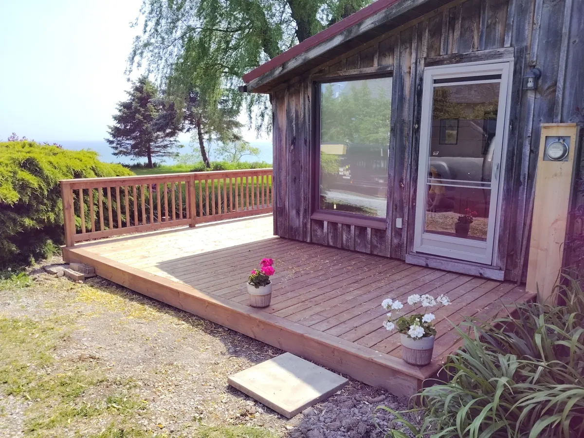 Finished cedar side deck with new railings beside the lakefront home