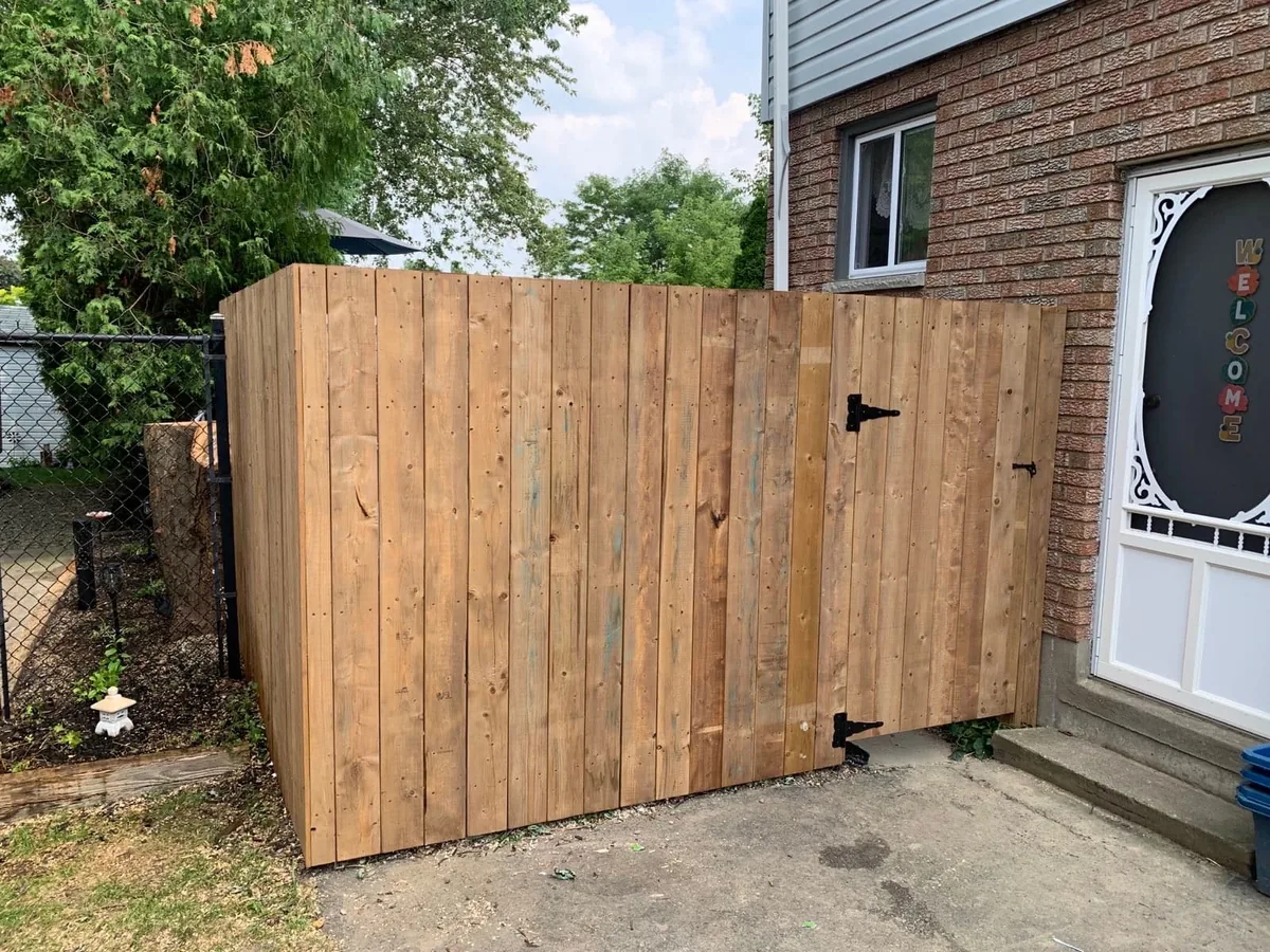 Tall cedar privacy fence with matching gate
