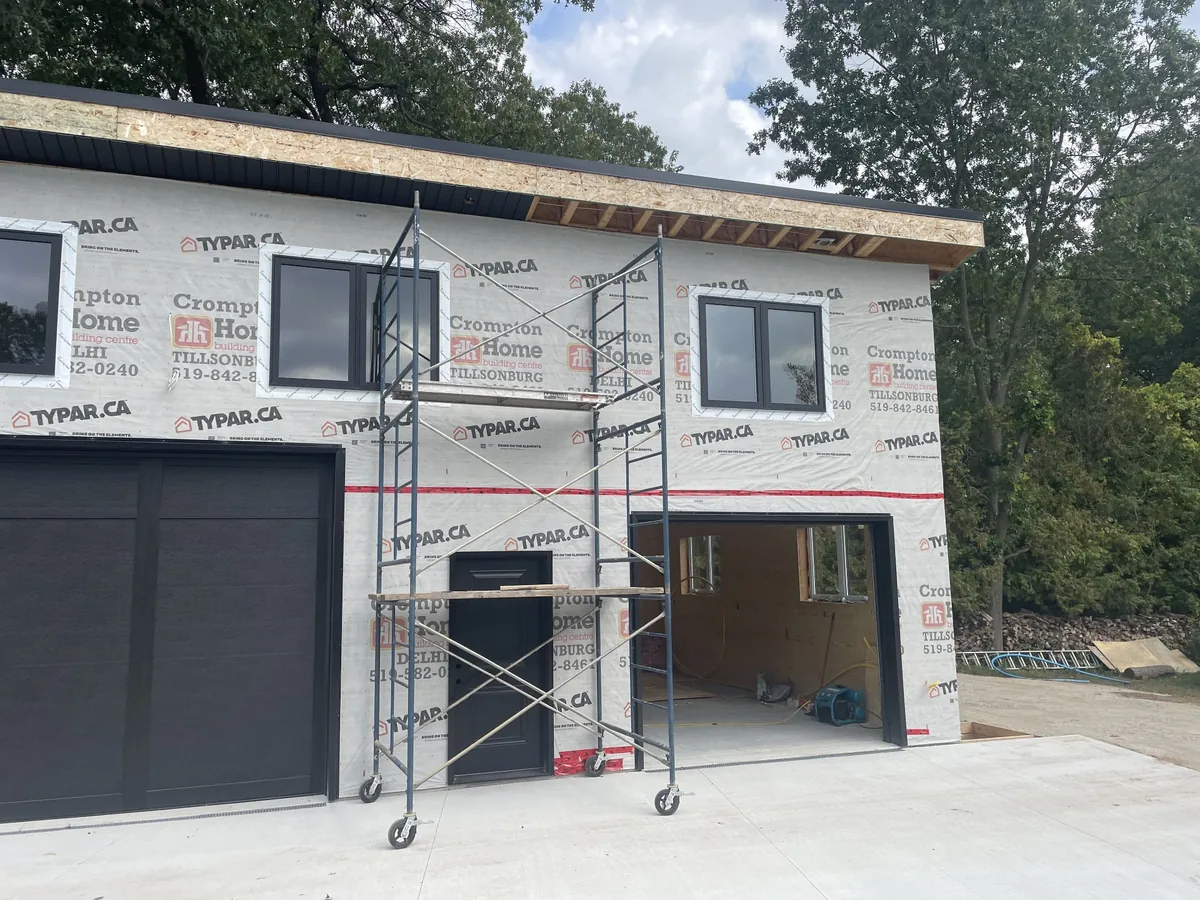 Garage addition exterior prepped for siding with windows and house wrap
