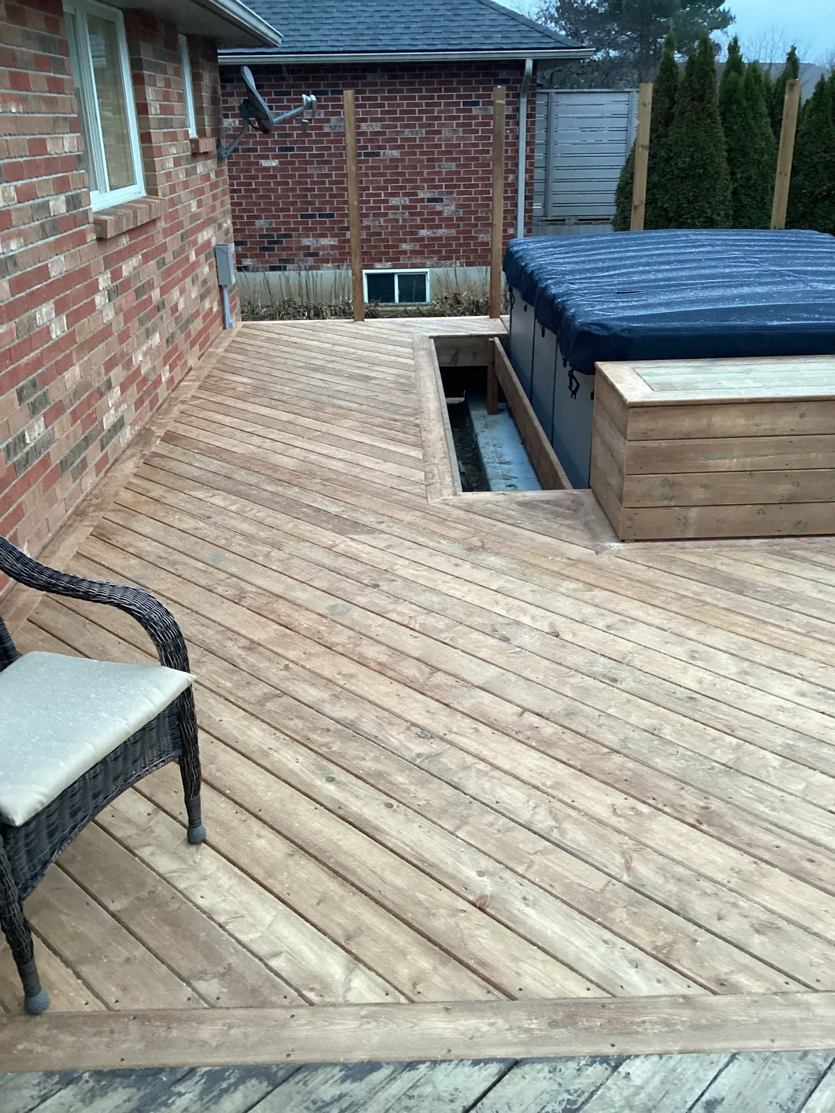 Cedar deck surface built around recessed hot tub