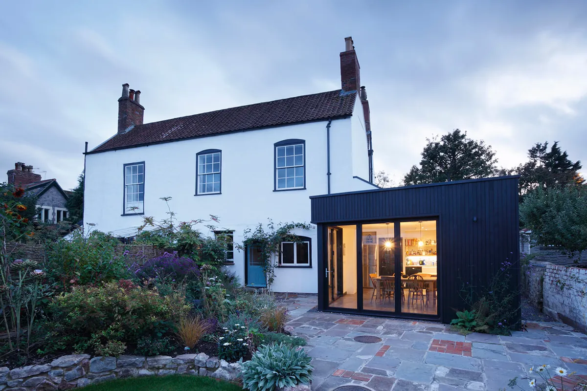 Modern black-clad rear addition on heritage home