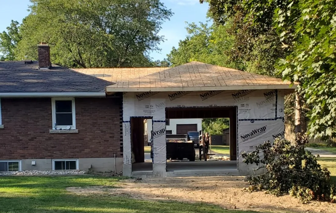 Garage addition framed and wrapped onto existing home
