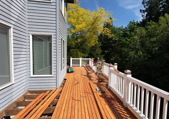 New cedar deck construction with white railing
