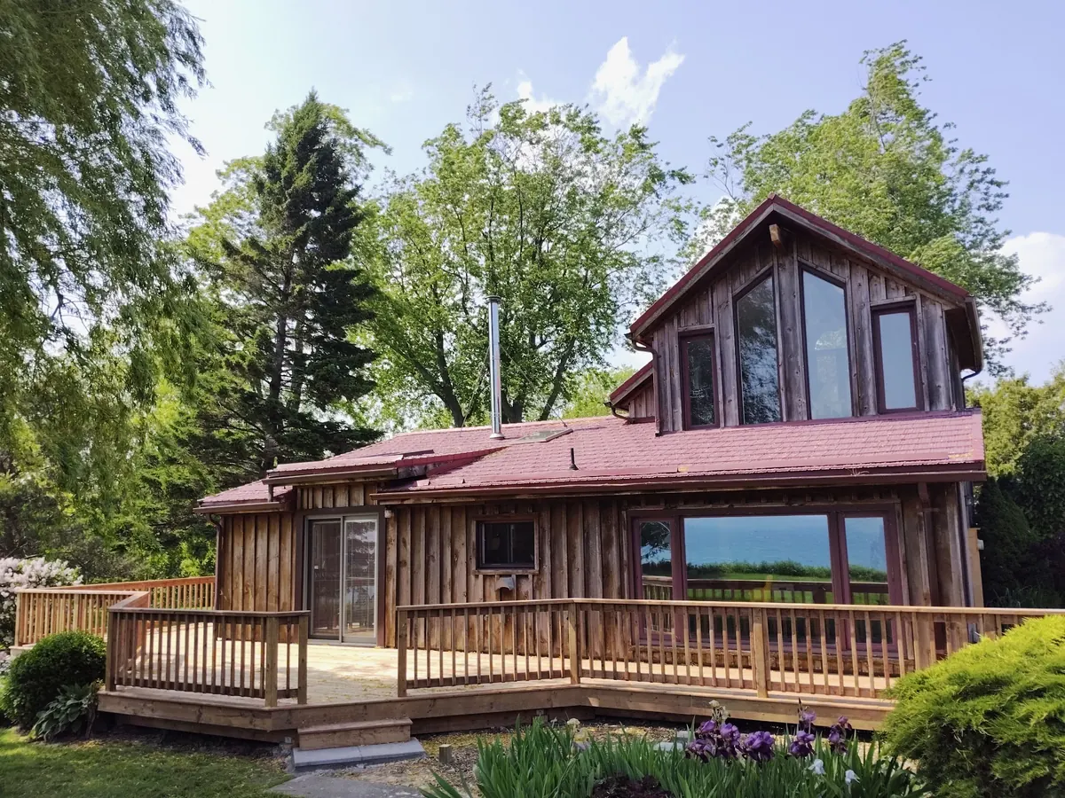 Wide exterior view of the completed cedar deck wrapping the lakefront home