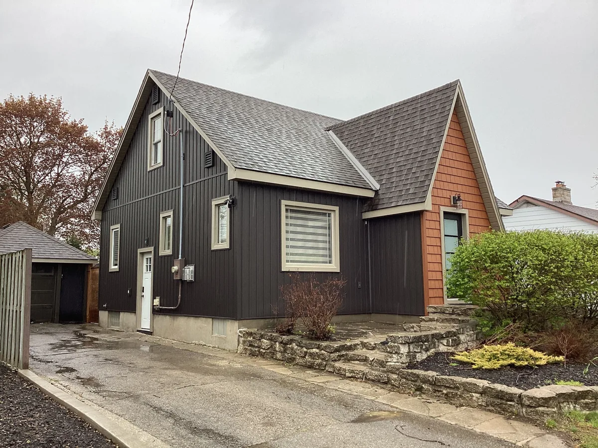 Dark board and batten home exterior with cedar shake accent gable