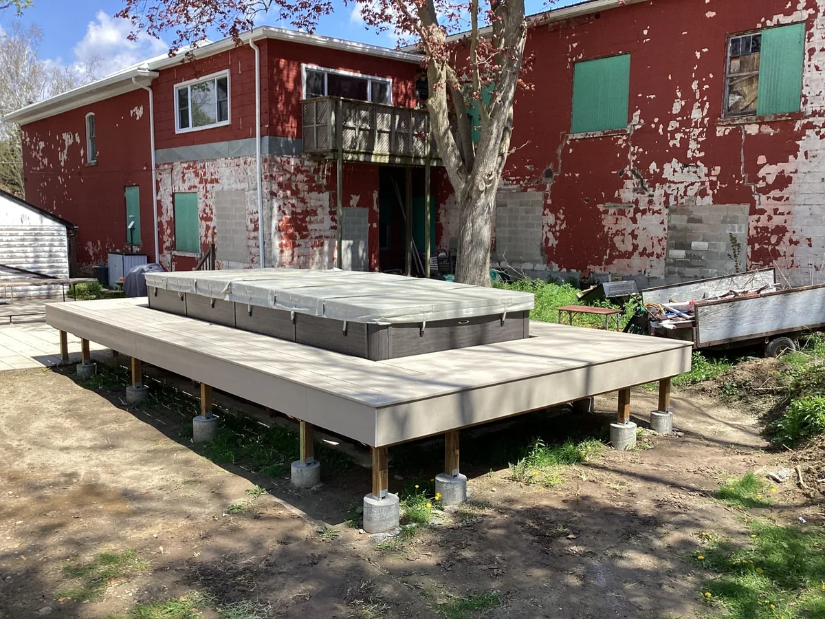 Low-profile composite deck with built-in hot tub surround