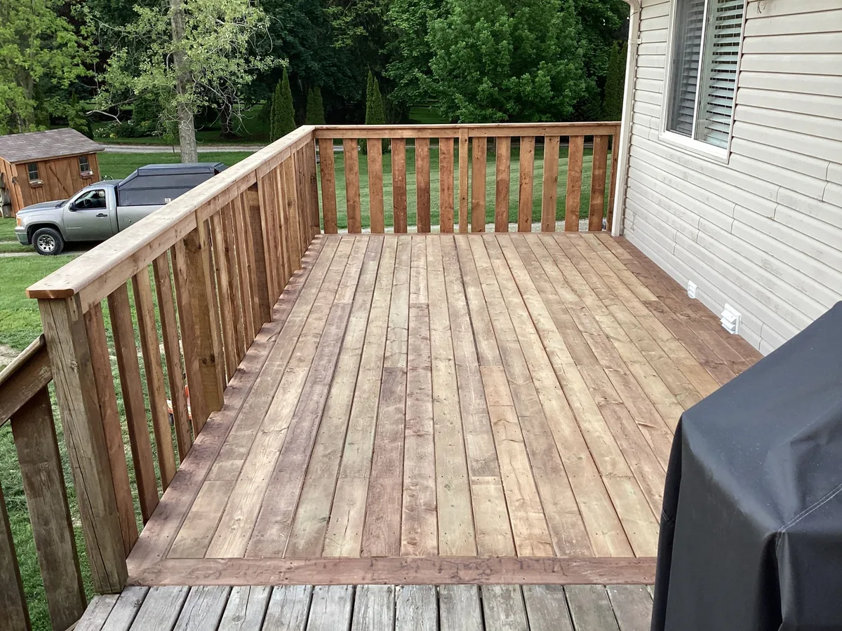Backyard cedar deck with picket style wood railings